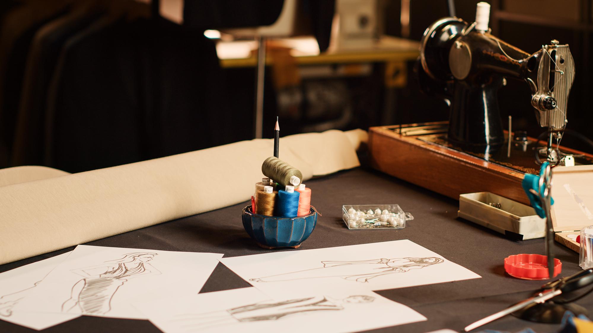 studio workbench with threads and sketches